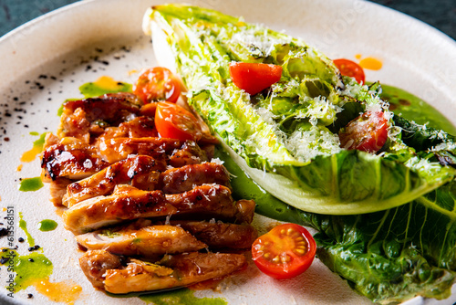 chicken grill meat served with pak choi vegetables on plate