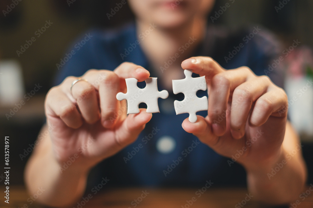 Businessman is holding two pieces of white jigsaw. Concept of solution solve. Business teamwork, connect, cooperation, partnership and strategy. Fix the problem. Match the idea. Brainstorming fit. Businessman is holding two pieces of white jigsaw. Concept of solution solve. Business teamwork, connect, cooperation, partnership and strategy. Fix the problem. Match the idea. Brainstorming fit.