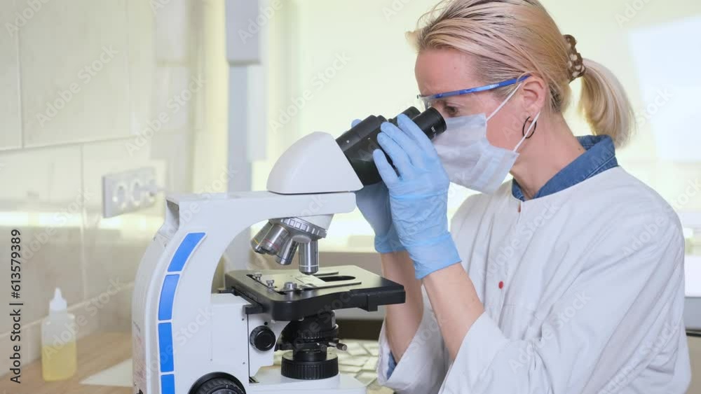 A laboratory assistant examines samples under a microscope. Scientific research in the laboratory. The concept of developing new medicines. Achievements in the field of biotechnology. A laboratory assistant examines samples under a microscope. Scientific research in the laboratory. The concept of developing new medicines. Achievements in the field of biotechnology.