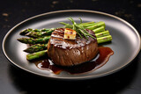 Grilled fillet mignon beef steak set, with onion and asparagus, on plate