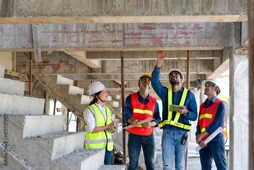 team of civil engineer manager, maintenance supervisor, technician foreman together with safety operator inspect and discuss the infrastructure of building construction progress at site