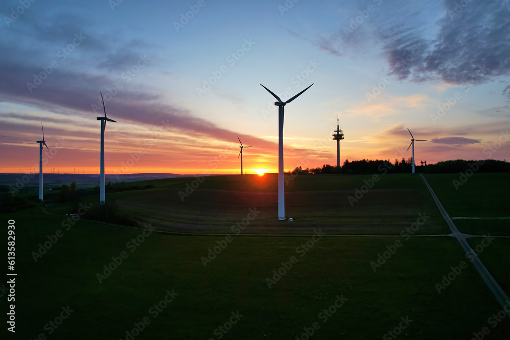 Wind energy as sustainable and renewable resource. Wind turbines for the production of bio power. Sunrise in germany. Aerial view with drone. Wind energy as sustainable and renewable resource. Wind turbines for the production of bio power. Sunrise in germany. Aerial view with drone.