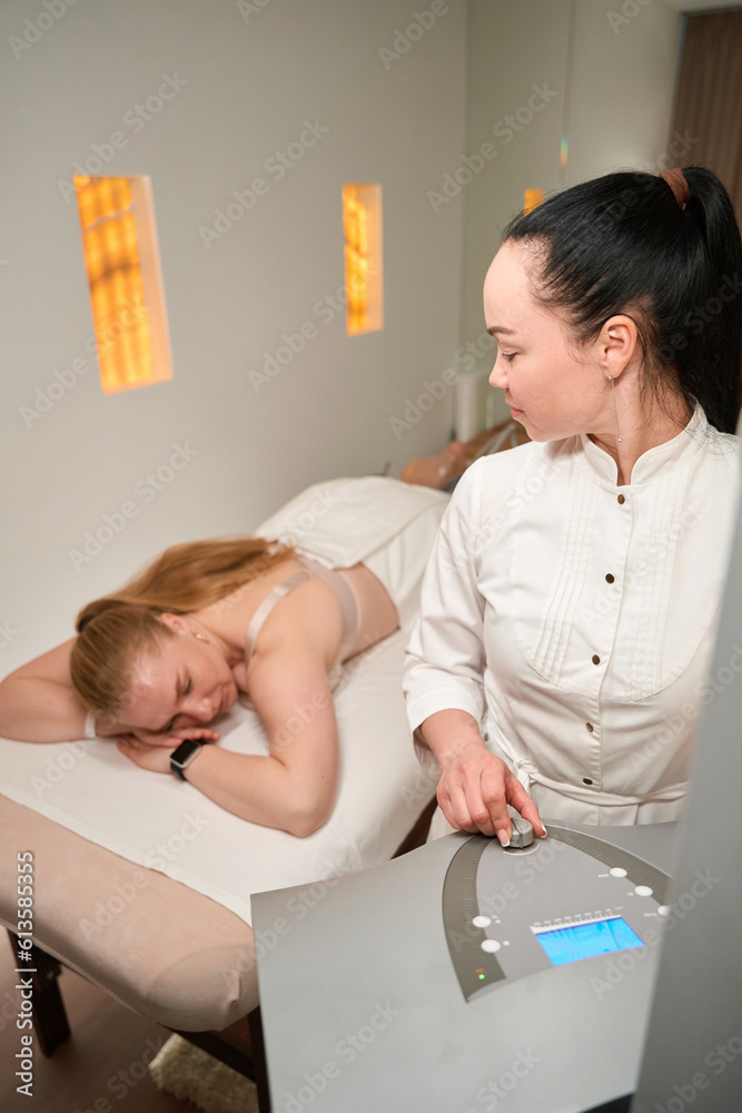 Female client is lying on a massage couch Female client is lying on a massage couch