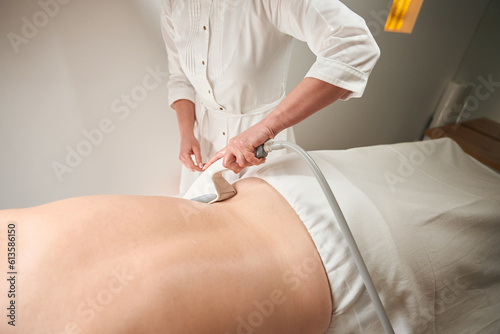 Female lies on the massage table with her back up