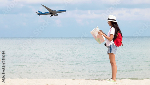 Summer Party. Traveler and tourism woman travel in summer on the beach and white sand. Asian is reading map with red backpack. On working in vacation concept.