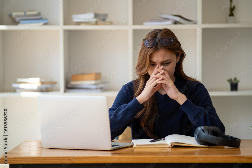 Stress, student with laptop at home frustrated agry unhappy young woman looking at laptop screen book, Exhausted female student studying online with computer Stress, student with laptop at home frustrated agry unhappy young woman looking at laptop screen book, Exhausted female student studying online with computer
