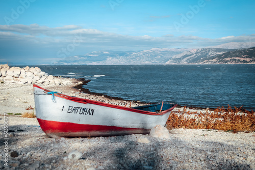 Abandoned boat on the shore of Egirdir lake with mountains in the distance and copy space - Isparta Region, Turkey 2022 photo