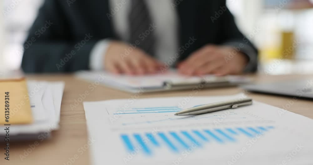 On the table of a business man, a report with a diagram and a pen, a close-up. Analysis and result of the company On the table of a business man, a report with a diagram and a pen, a close-up. Analysis and result of the company