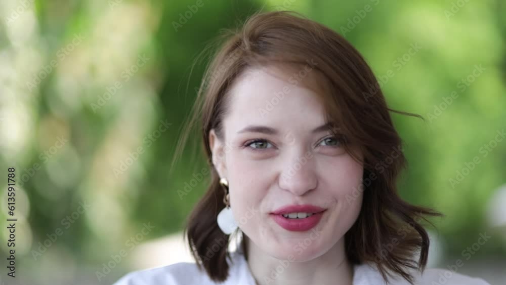 beautiful woman talking in front of the camera on a natural background, interview, blogging beautiful woman talking in front of the camera on a natural background, interview, blogging