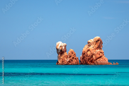 Cea beach with the Red Rocks, the Red Rocks - Faraglioni. White sand and crystal clear water. Tortoli, Ogliastra, Sardinia, Italy photo