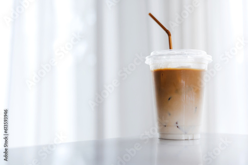 Plastic takeaway cups of delicious iced coffee on table in cafe , There is space for text in the background , 