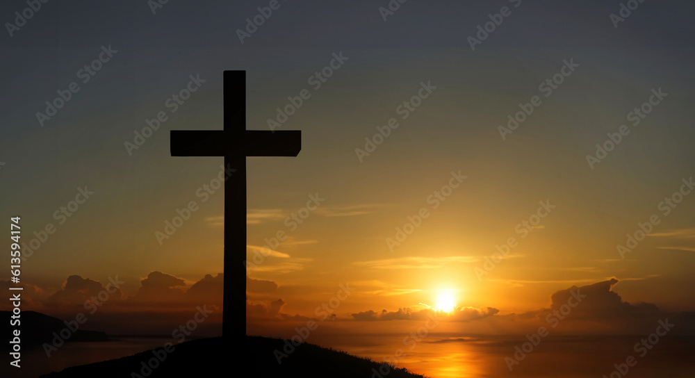The cross standing on mountain sunset and flare background. Cross on a hill as the morning sun comes up for the day. The cross symbol for Jesus Christ. Easter background concept and The crosses sign.