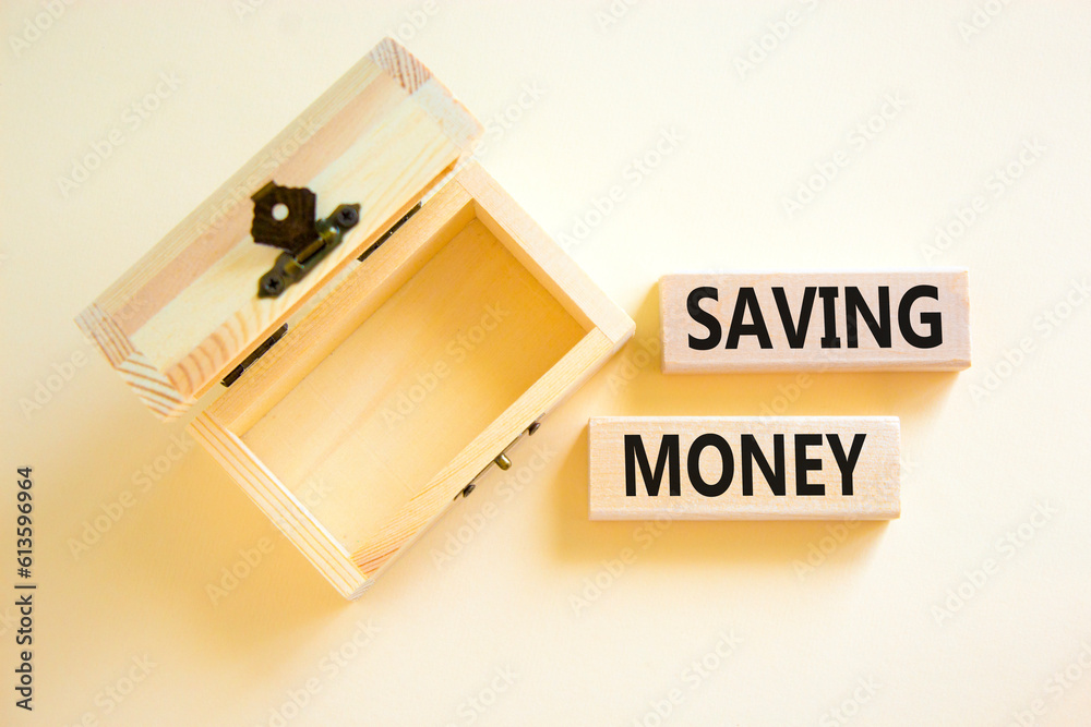 Saving money symbol. Concept words Saving money on wooden blocks on a beautiful white table white background. Empty wooden chest. Business, support and saving money concept. Copy space.