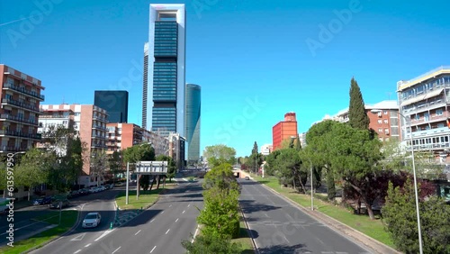 Paseo de la castellana de la ciudad de Madrid sin carteles publicitarios y con poco tráfico un día soleado con cielo azul. photo