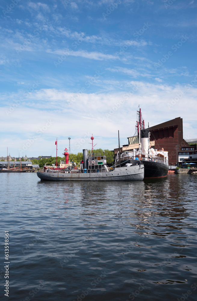Old museums boats at a pier in the bay Ladugårdslandsviken, a sunny summer day in Stockholm