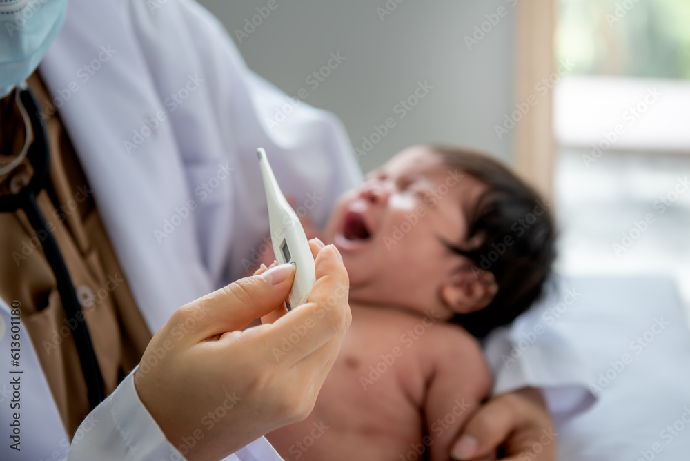 Doctor holding a temperature measuring device, for measuring the fever of a baby newborn girl, 1-month-old. to health care and baby newborn concept. Doctor holding a temperature measuring device, for measuring the fever of a baby newborn girl, 1-month-old. to health care and baby newborn concept.