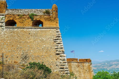 Nafplio, Greece Palamidi fortress bastions Miltiadis and Leonidas with a Greek flag waving against a blue sky.