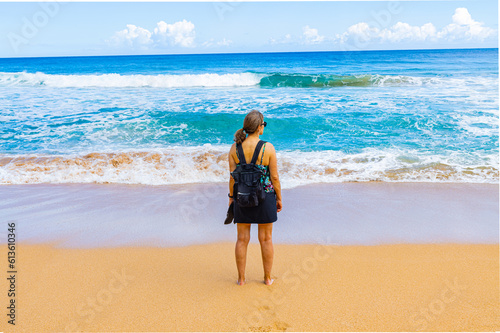 Female Tourist on The Sandy Shore of  Kauapea Beach, Kauai, Hawaii, USA photo