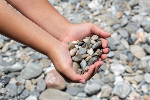 Close-up of hands showing a set of stones. Beaches of rocks