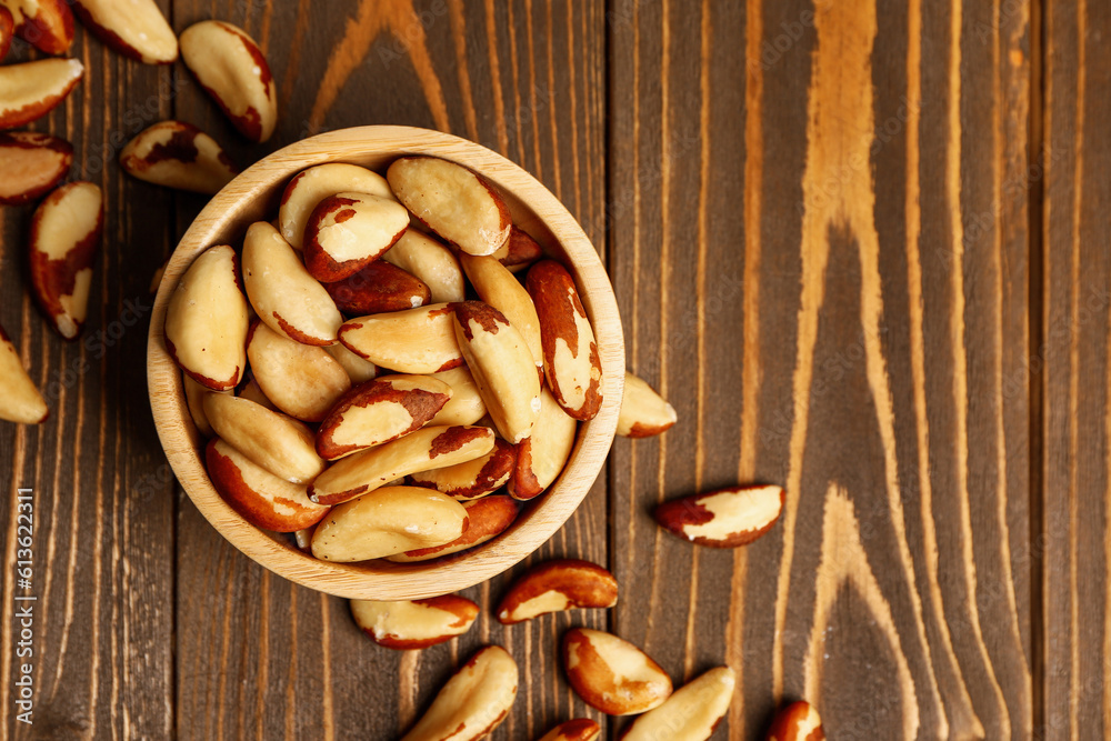 Bowl of tasty Brazil nuts on wooden background Bowl of tasty Brazil nuts on wooden background