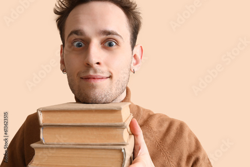 Young man reading book on b...