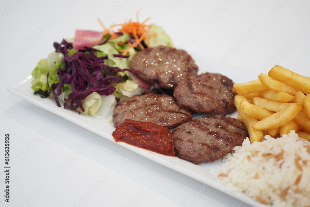 Kebab, traditional turkish meat food with salad on a plate Kebab, traditional turkish meat food with salad on a plate