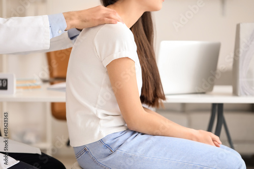 Male doctor checking postur...