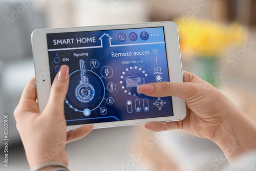 Young woman using smart home security system control panel, closeup