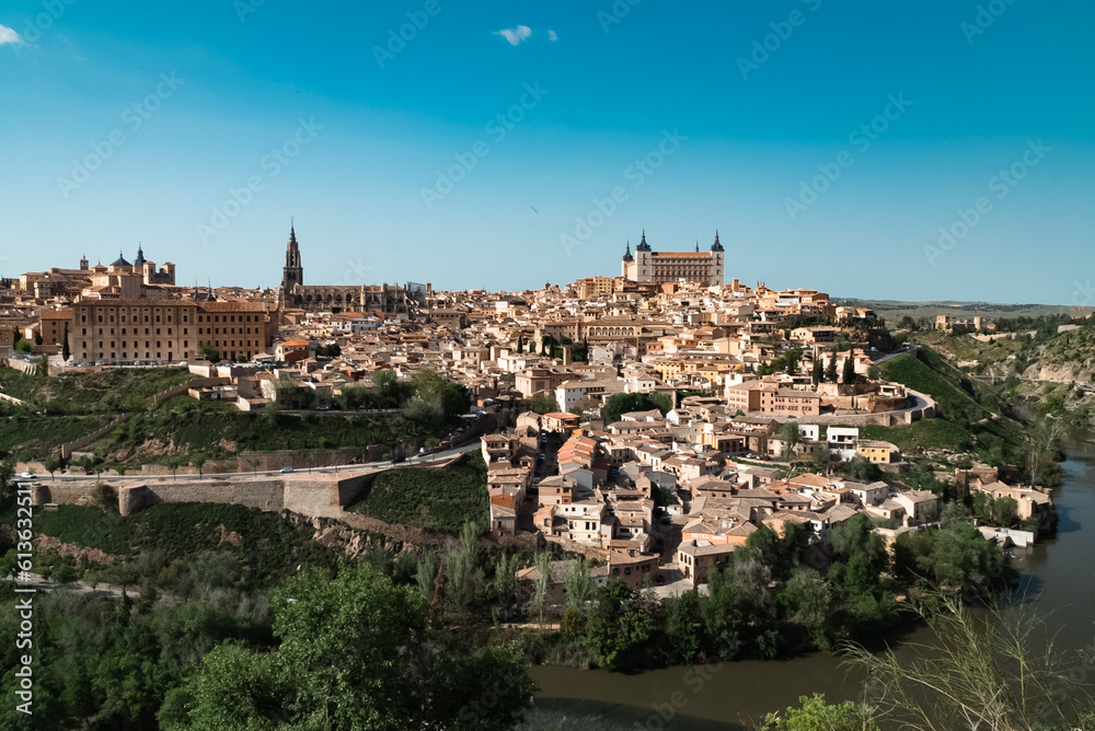 Panoramic landscape with beautiful blue sky and view of the Tagus river in the city of Toledo, Spain.