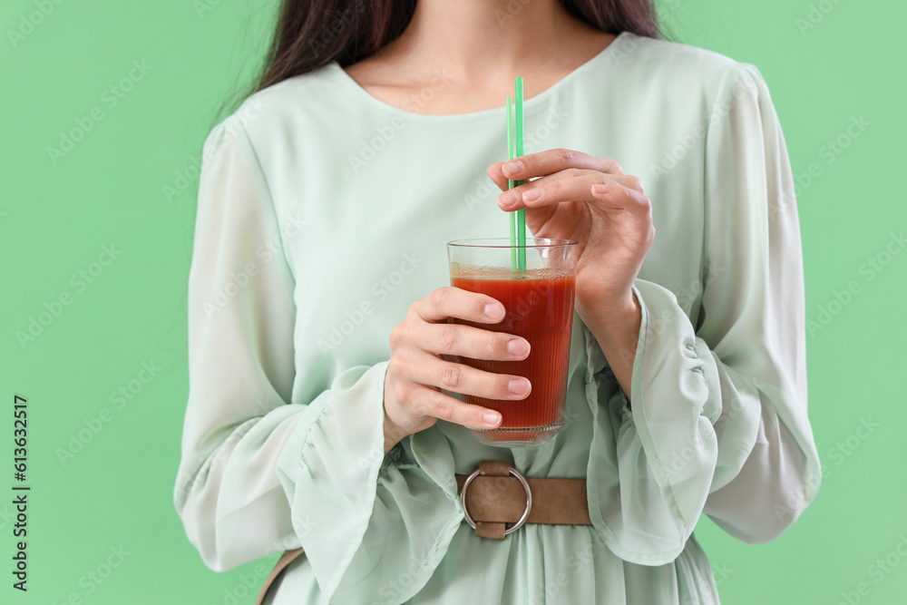 Young woman with glass of vegetable juice on green background, closeup Young woman with glass of vegetable juice on green background, closeup