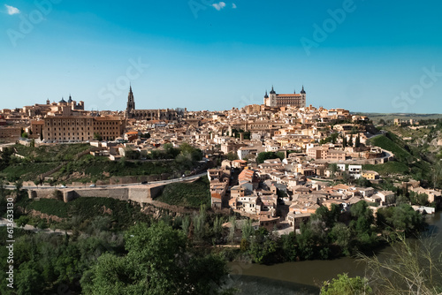 Panoramic landscape with beautiful blue sky and view of the Tagus river in the city of Toledo, Spain. © camaralucida1