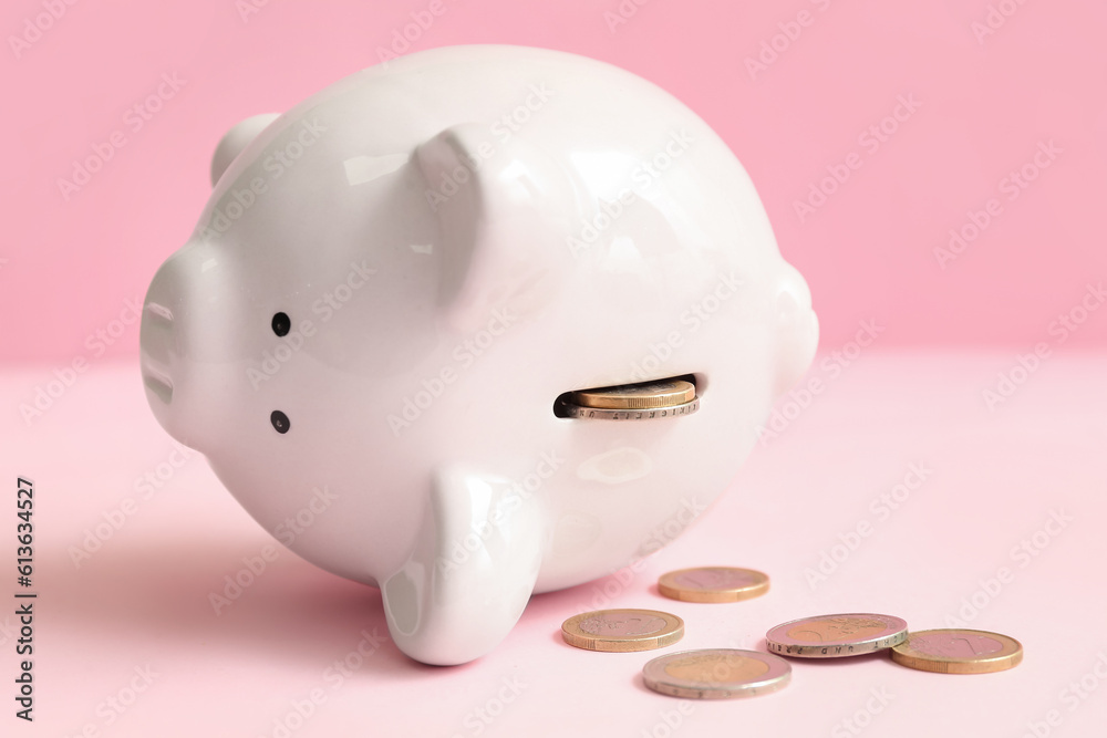Piggy bank with money on pink background. Bankruptcy concept