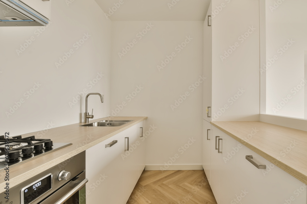 a kitchen with white cabinets and wood counter tops in an apartment near london, england by corbo architects a kitchen with white cabinets and wood counter tops in an apartment near london, england by corbo architects