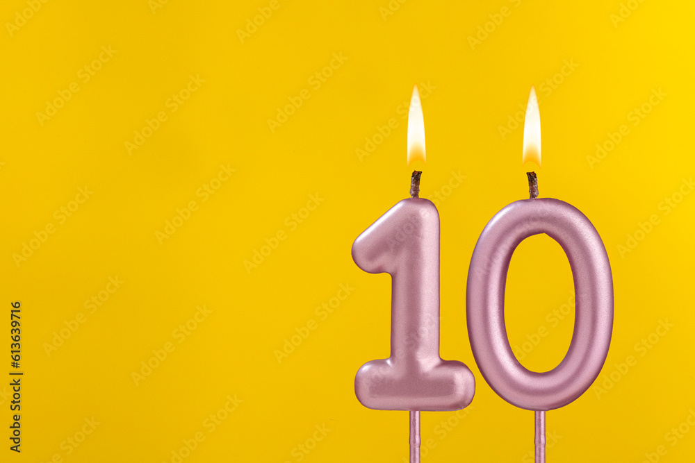Birthday candle number 10 - Birthday celebration on yellow background