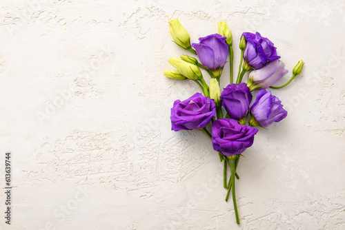 Composition with beautiful fresh eustoma on light background