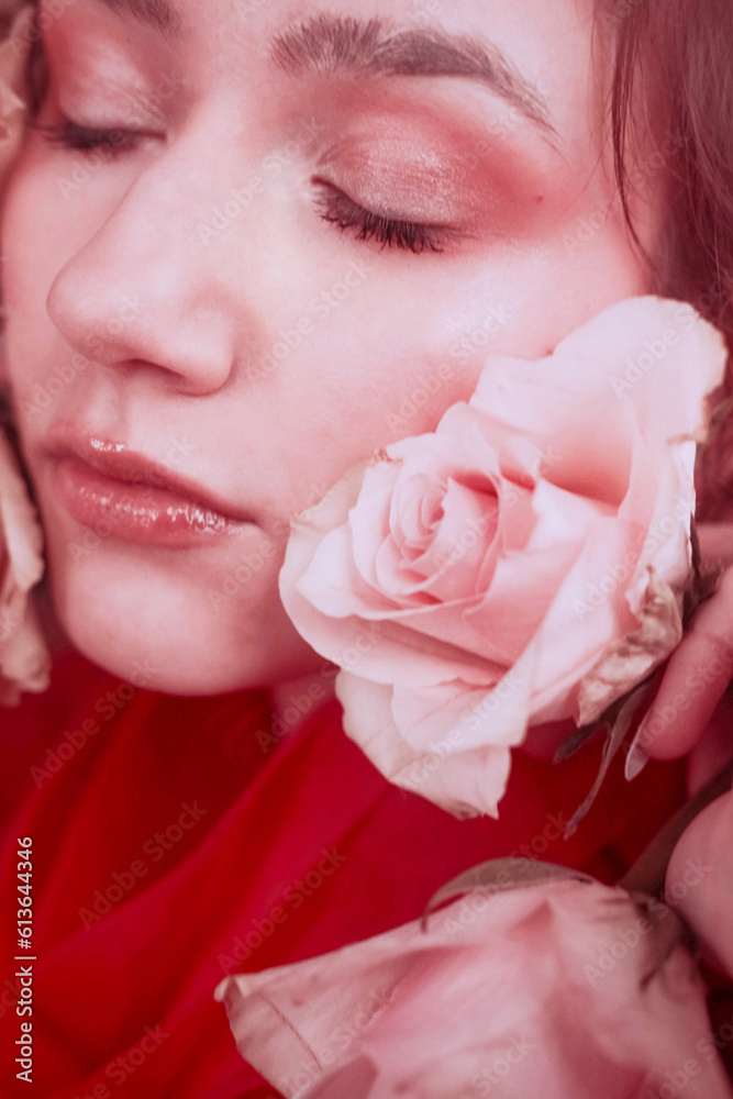Pink portraits of a young girl with red roses on her face Pink portraits of a young girl with red roses on her face