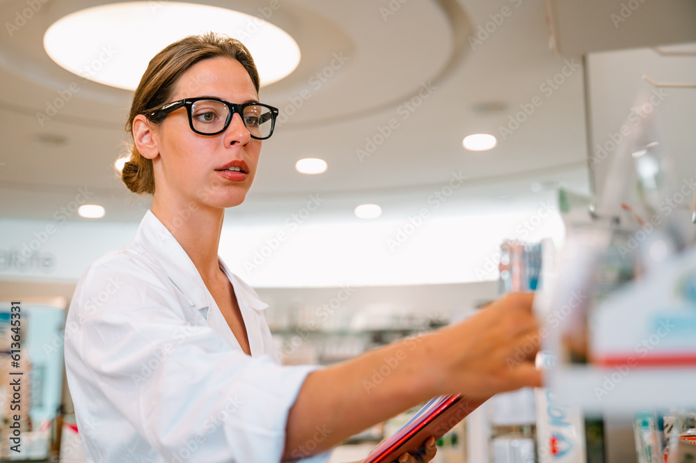 Woman working in the pharmacy looks for the medicine