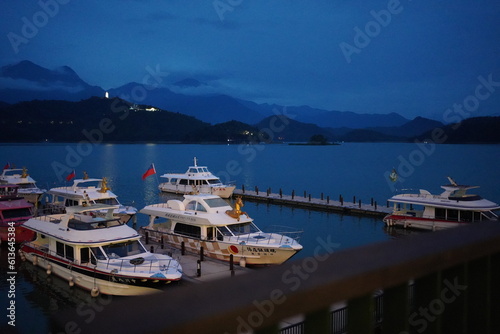 boat on lake in dusk, sun moon lake taiwan