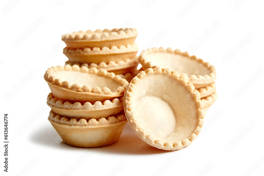 Empty tartlet shells isolated on white. Stacked crispy mini tart shells closeup Empty tartlet shells isolated on white. Stacked crispy mini tart shells closeup