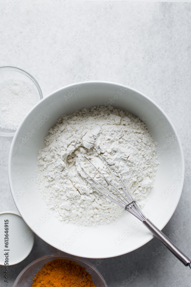 All purpose flour in a white bowl, baking flour in a large bowl All purpose flour in a white bowl, baking flour in a large bowl
