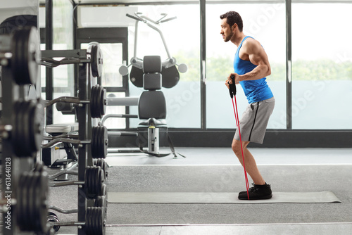 Man exercising with a resistance band at the gym