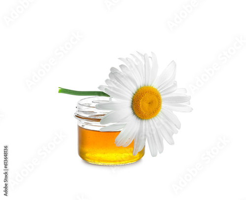 Jar of honey and beautiful chamomile flower on white background