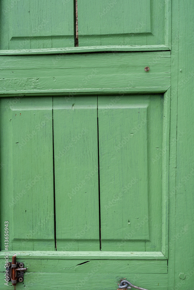 Beautiful green wood jalousie on window of old building. Beautiful green wood jalousie on window of old building.