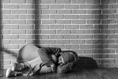 Beaten young woman lying ne...