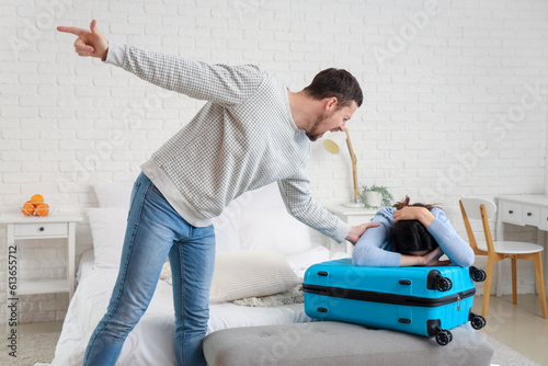 Angry husband kicking his w...