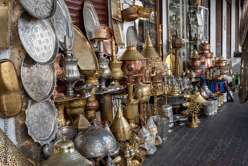 Lanterns, plates and vases in embossed metal, typical Moroccan craftsmanship under the arches of Rue Ibn Khaldoun, in the medina of the Habaus district of Casablanca. photo
