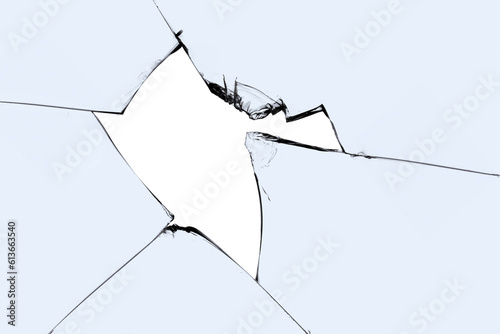 A broken window with cracks and pieces of sharp glass. Cracked texture for design.