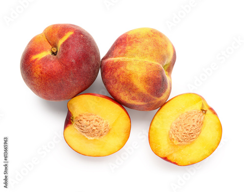 Halves of sweet peach on white background