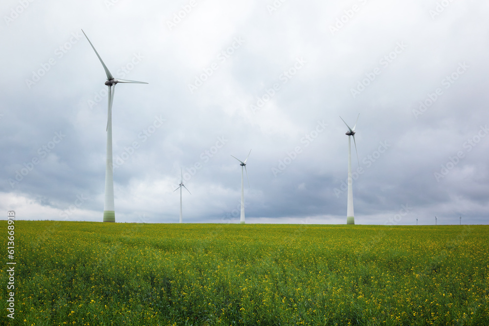 Wind power plant. green meadow with Wind turbines generating electricity. Wind power plant. green meadow with Wind turbines generating electricity.