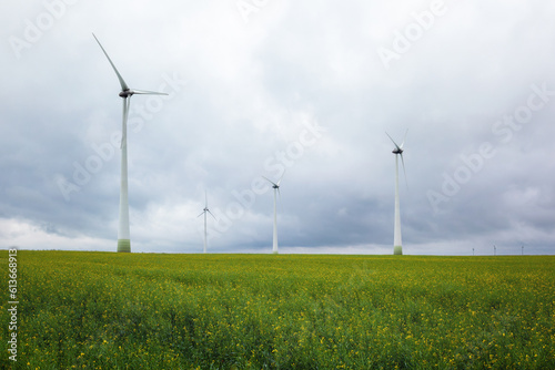 Wind power plant. green meadow with Wind turbines generating electricity.